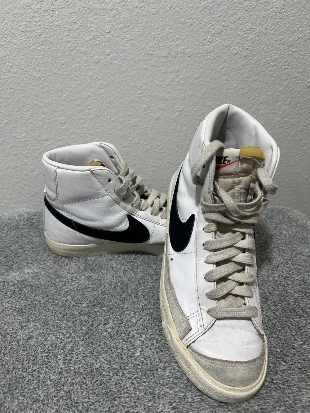 Nike White High-Top Sneakers with Black Swoosh